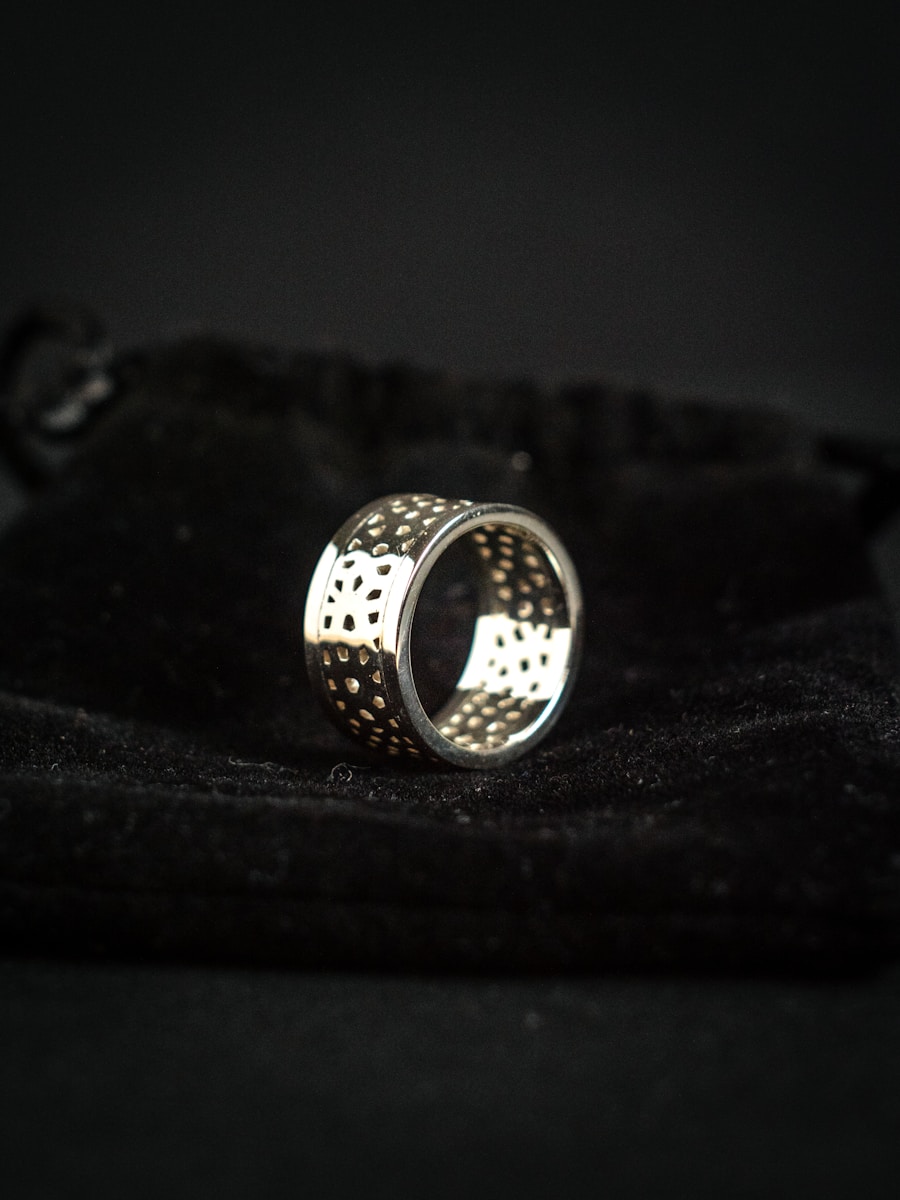 silver ring on black textile